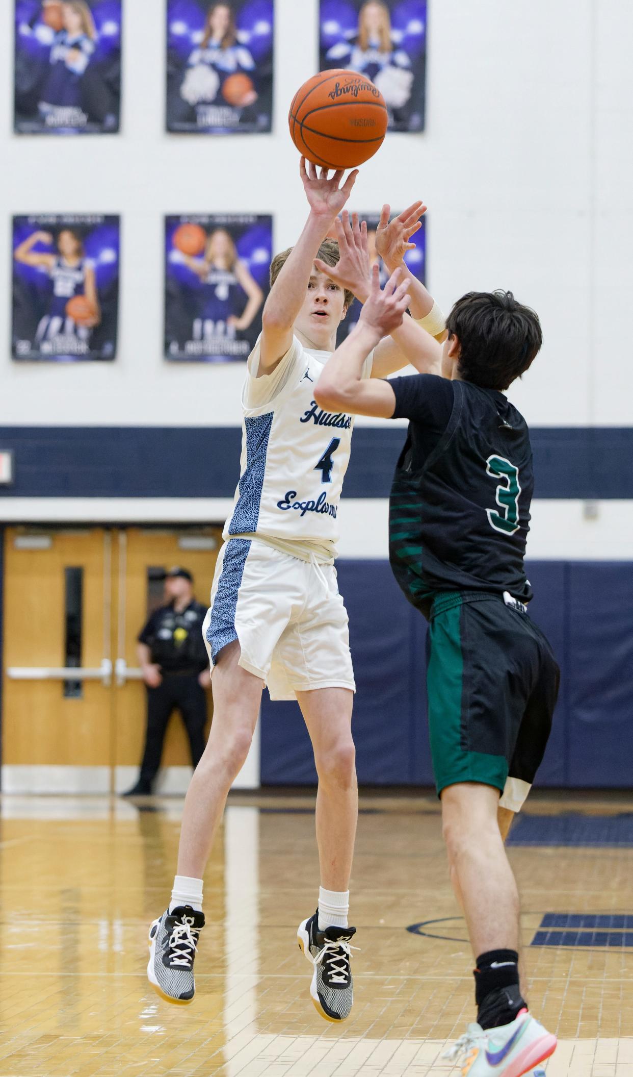Hudson's Fritz Trautman hits a series a three-pointer over Nordonia's Trevor Turnbull during a game earlier this season.