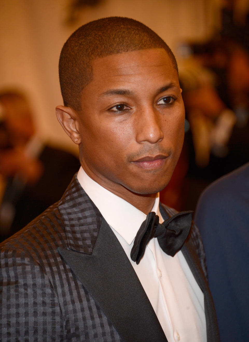 Pharrell Williams in a patterned tuxedo with a bow tie