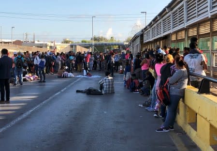 Migrants, returned to Mexico to await their U.S. asylum hearing as they block the Puerta Mexico international border crossing bridge to demand quickness in their asylum process in Matamoros