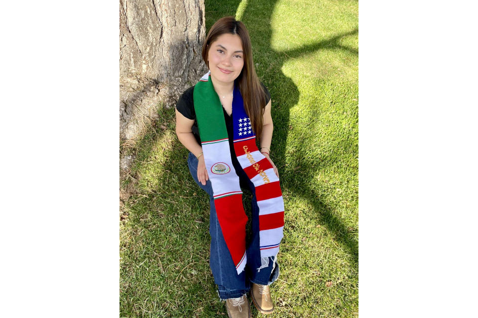 In this undated photo, Naomi Peña Villasano poses with a sash of both the Mexican and American flags that her school district barred her from wearing for her high school graduation ceremony. After Peña Villasano sued the district alleging that it violated her right to free speech, a federal judge in Colorado is weighing whether to let Peña Villasano wear the sash for graduation Saturday, May 27, 2023. (Daisy Jasmin Estrada Borja via AP)