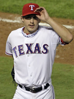 Rangers starting pitcher Derek Holland tips his cap after being removed in the ninth inning of Game 4 of the World Series