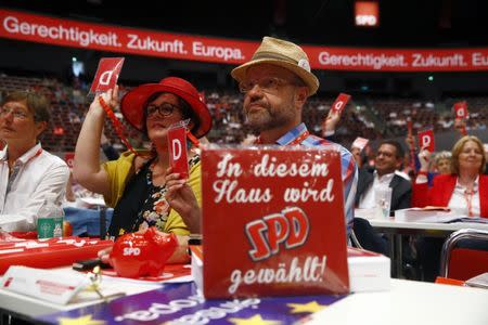 Delegates of the German Social Democratic party (SPD) vote during the party convention in Dortmund, Germany, June 25, 2017. REUTERS/Wolfgang Rattay