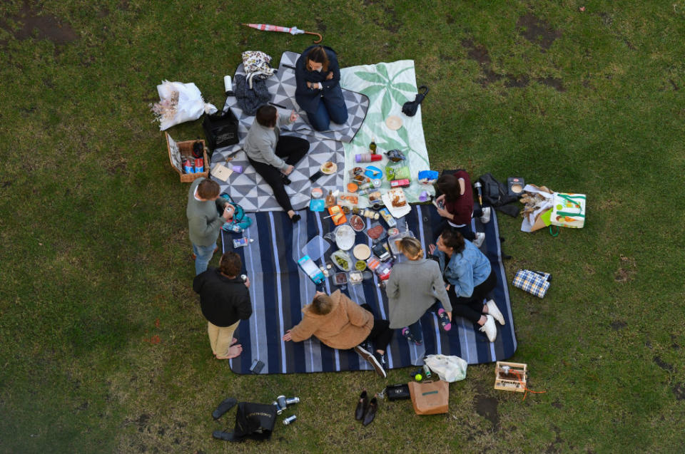 A group of friends enjoy a birthday picnic at Bradfield Park, Milsons Point in Sydney, Australia. 