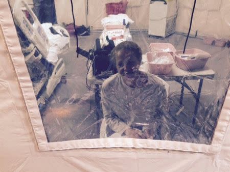 Kaci Hickox, a nurse who arrived in New Jersey on October 24 after treating Ebola patients in West Africa, speaks to her lawyer Norman Siegel from a hospital quarantine tent in Newark, New Jersey, October 26, 2014, in a photo provided by attorney Steve Hyman. REUTERS/Steve Hyman/handout via Reuters