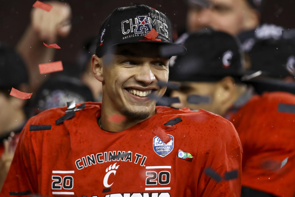 Cincinnati quarterback Desmond Ridder reacts on the field following the American Athletic Conference championship NCAA college football game against Tulsa, Saturday, Dec. 19, 2020, in Cincinnati. Cincinnati won 27-24. (AP Photo/Aaron Doster)