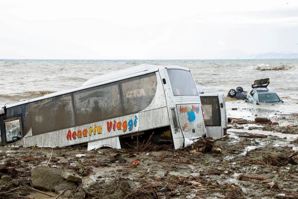 Cars and local tour buses wash out to sea (Reuters)