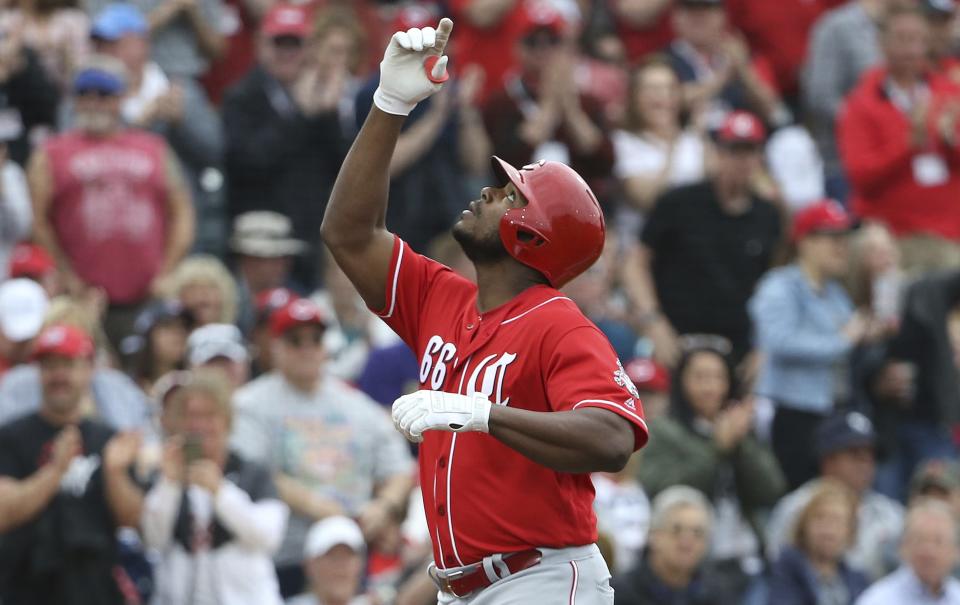 Cincinnati Reds' Yasiel Puig points to the sky as he celebrates his home run against the Cleveland Indians during the third inning of a spring training baseball game Monday, March 11, 2019, in Goodyear, Ariz. (AP Photo/Ross D. Franklin)