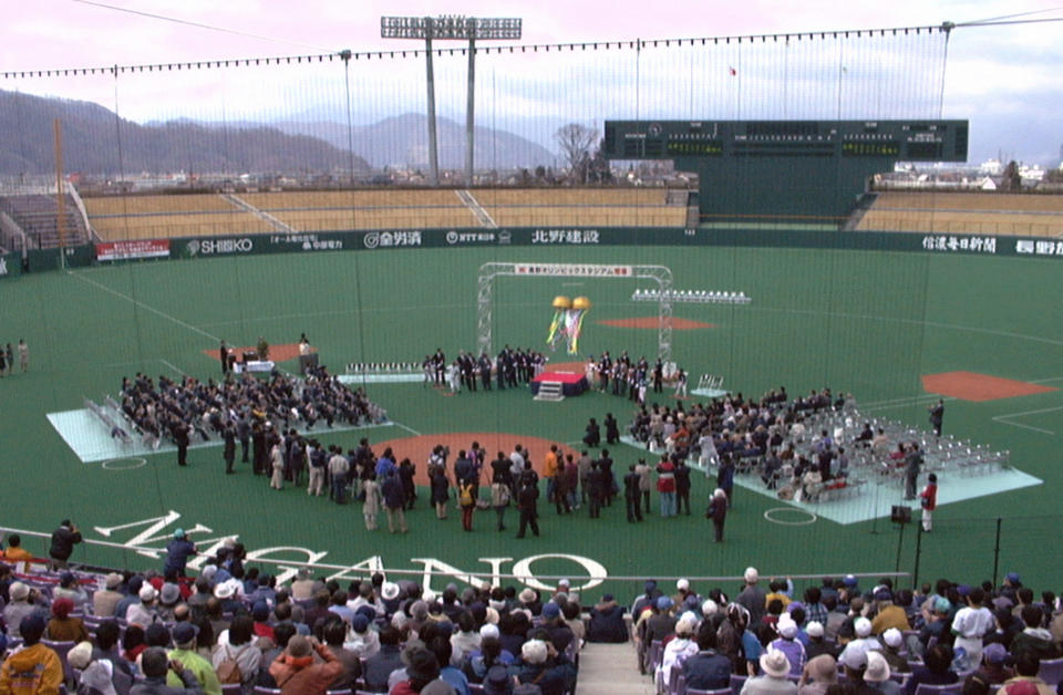 In this April 16, 2000 photo, a ceremony is held to unveil a baseball stadium, also known as the Olympic Stadium, which was used for the opening and closing ceremony for the 1998 Nagano Winter Olympics, in Nagano, central Japan. In Nagano, a city with a population of just 387,000, five large structures were built for the 1998 Winter Games. They remain in use, though many complain that the venues are too big and costly to maintain for the size of the town. (AP Photo/Kyodo News) JAPAN OUT.