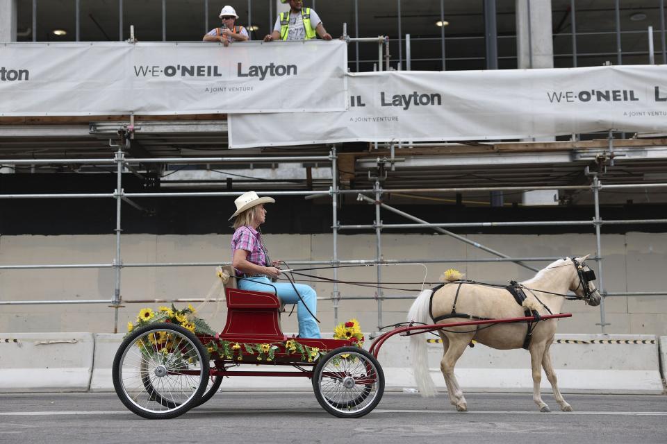 Construction workers watch as a Utah miniature horse and buggy passes by during the Days of ‘47 Parade in Salt Lake City on Monday, July 24, 2023. | Laura Seitz, Deseret News