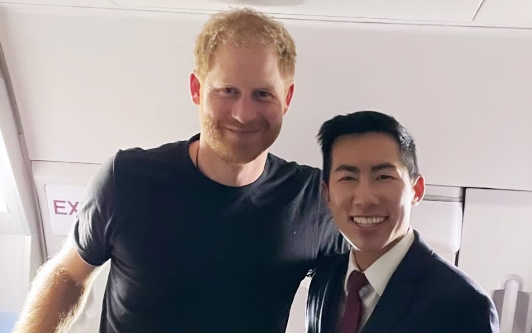 The flight attendant shared a picture of himself with the Duke of Sussex on the American Airlines journey