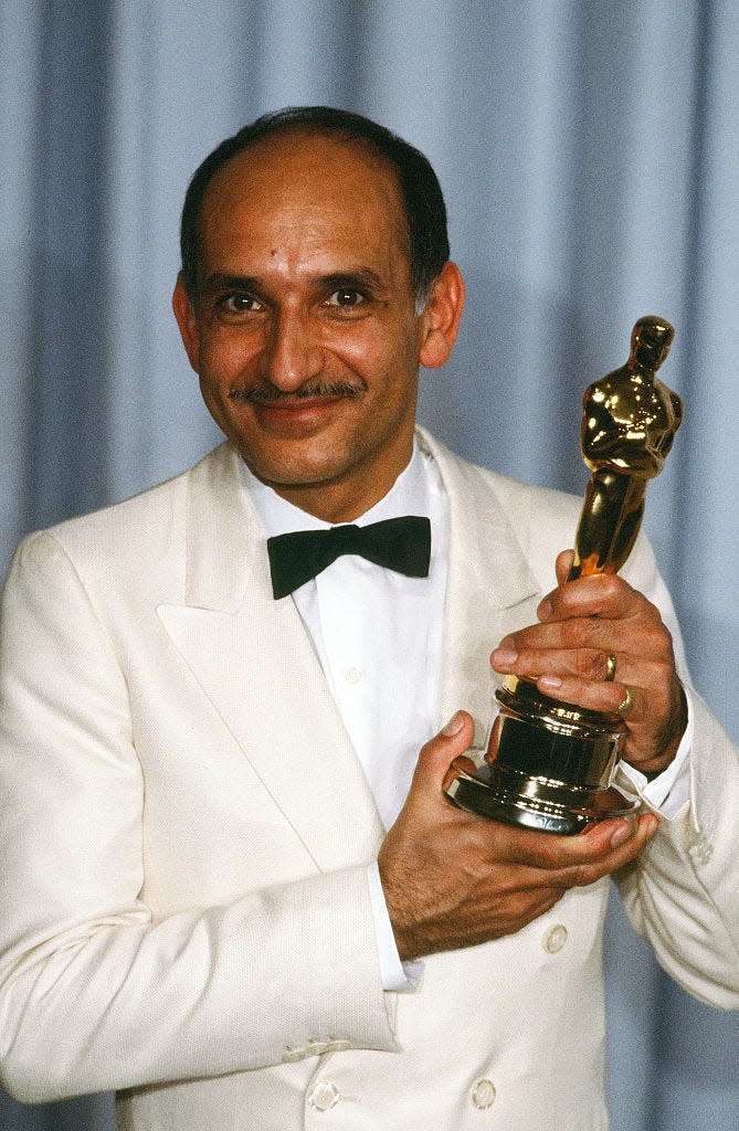 Ben Kingsley holding Academy Award for performance in Gandhi in 1982.