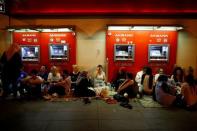 People sit in front of ATM machines of a bank as they gather in solidarity night after night since the July 15 coup attempt in central Ankara, Turkey, July 27, 2016. REUTERS/Umit Bektas