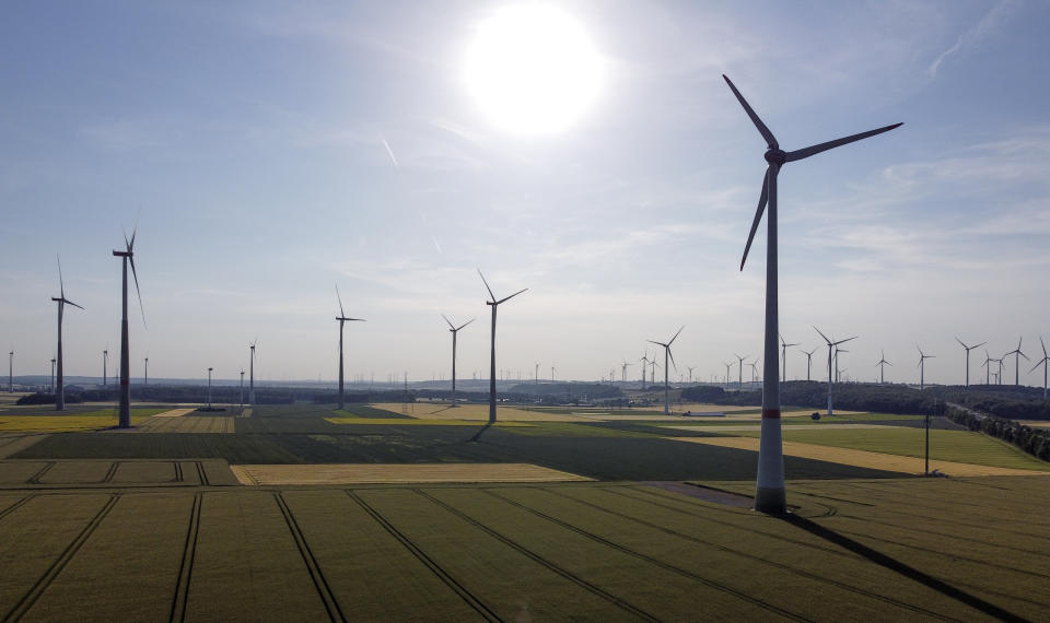 FILE - Wind turbines stand at a wind park in Marsberg, Germany, June 15, 2022. The European Union's decision to include natural gas in a list of activities considered sustainable could derail progress in reducing greenhouse gas emissions at a time when climate scientists are calling for dramatic reductions to planet-warming releases. While Europe is working on transitioning to renewable sources such as wind and solar, it doesn't have enough power lines in place to carry electricity from sunny solar farms and wind-fired turbines. (AP Photo/Martin Meissner, File)