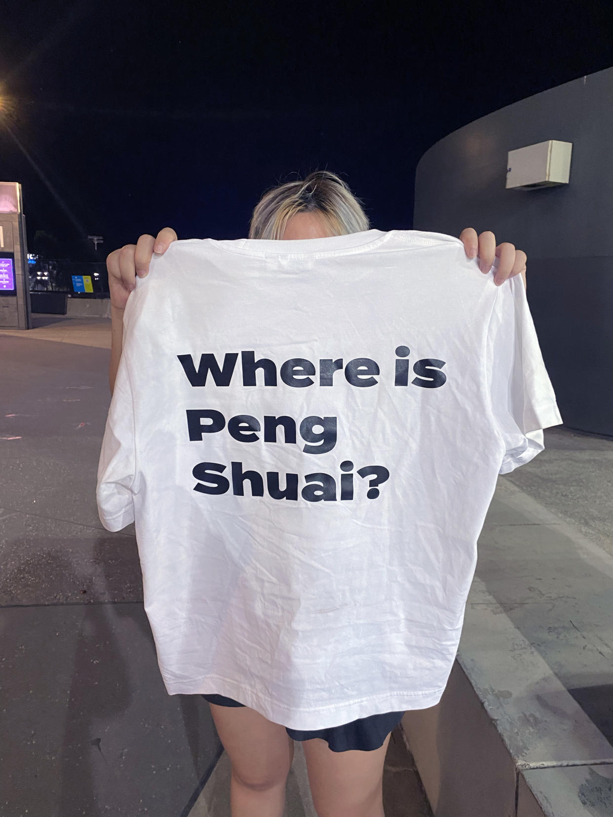 Xiao, una artista nacida en China y radicada en Melbourne, sostiene una camiseta que diseñó para hacer notar la mala situación de la estrella china del tenis Peng Shuai. (Ben Rothenberg vía The New York Times)
