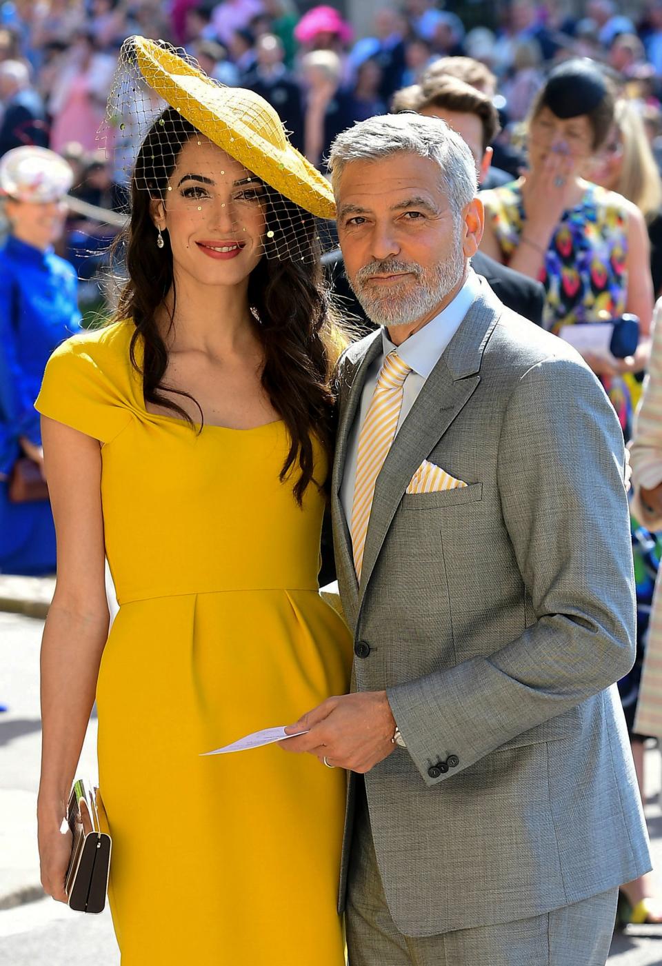 TOPSHOT - US actor George Clooney (R) and his wife British lawyer Amal Clooney (L) arrive for the wedding ceremony of Britain's Prince Harry, Duke of Sussex and US actress Meghan Markle at St George's Chapel, Windsor Castle, in Windsor, on May 19, 2018. (Photo by Ian West / POOL / AFP)        (Photo credit should read IAN WEST/AFP via Getty Images)