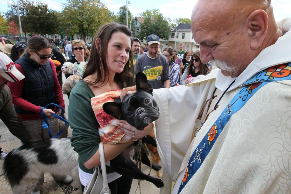 The Rev. Mike Hammer blessed pets October 6, 2013 at the Brady Steet Doggie Parade. For his lifetime of work in the Milwaukee neighborhood, Hammer earned the nickname "the bishop of the east side."