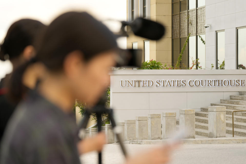 Journalists wait for WikiLeaks founder Julian Assange outside the court where he is expected to enter a plea deal, in Saipan, Mariana Islands, Wednesday, June 26 2024. (AP Photo/Eugene Hoshiko)