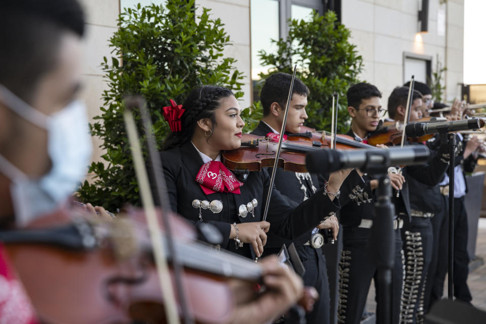 FILE - Members of the Odessa High School mariachi band perform at a Cinco de Mayo celebration hosted by the Odessa Hispanic Chamber of Commerce at the Odessa Marriott Hotel and Convention Center, Wednesday, May 5, 2021, in Odessa, Texas. The United States is gearing up for Cinco de Mayo. Music, all-day happy hours and deals on tacos are planned at venues across the country on May 5, 2024 in a celebration with widely misunderstood origins that is barely recognized south of the border. (Eli Hartman/Odessa American via AP, file)