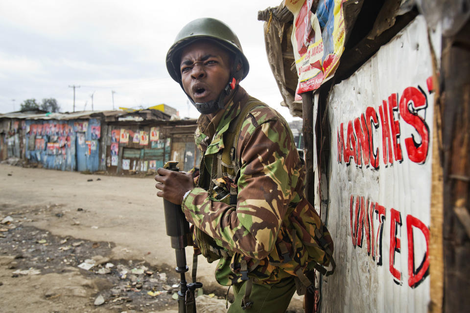 <p>A Kenyan security forces officer shout before firing a tear gas canister to chase supporters of Kenyan opposition leader and presidential candidate Raila Odinga who demonstrate in the Mathare area of Nairobi Wednesday, Aug. 9, 2017. (Photo: Jerome Delay/AP) </p>