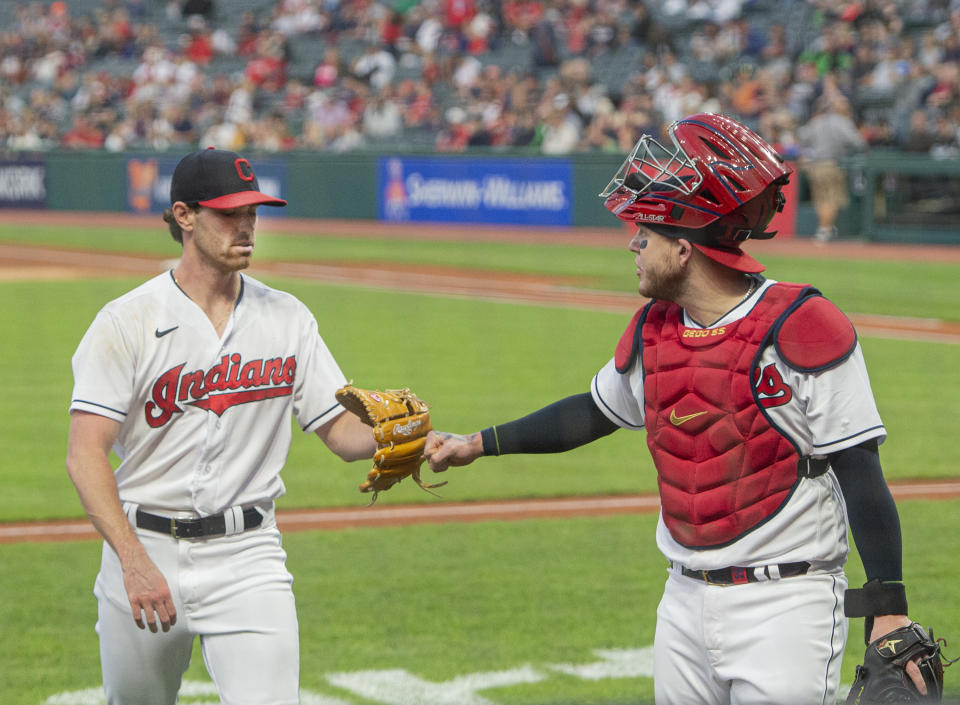 Cleveland Indians starting pitcher Shane Bieber gets a fist bump from Roberto Perez after getting the Chicago White Sox's out during the first inning of a baseball game in Cleveland, Friday, Sept. 24, 2021. Bieber, sidelined with an arm injury is making his first start since June 13. (AP Photo/Phil Long)