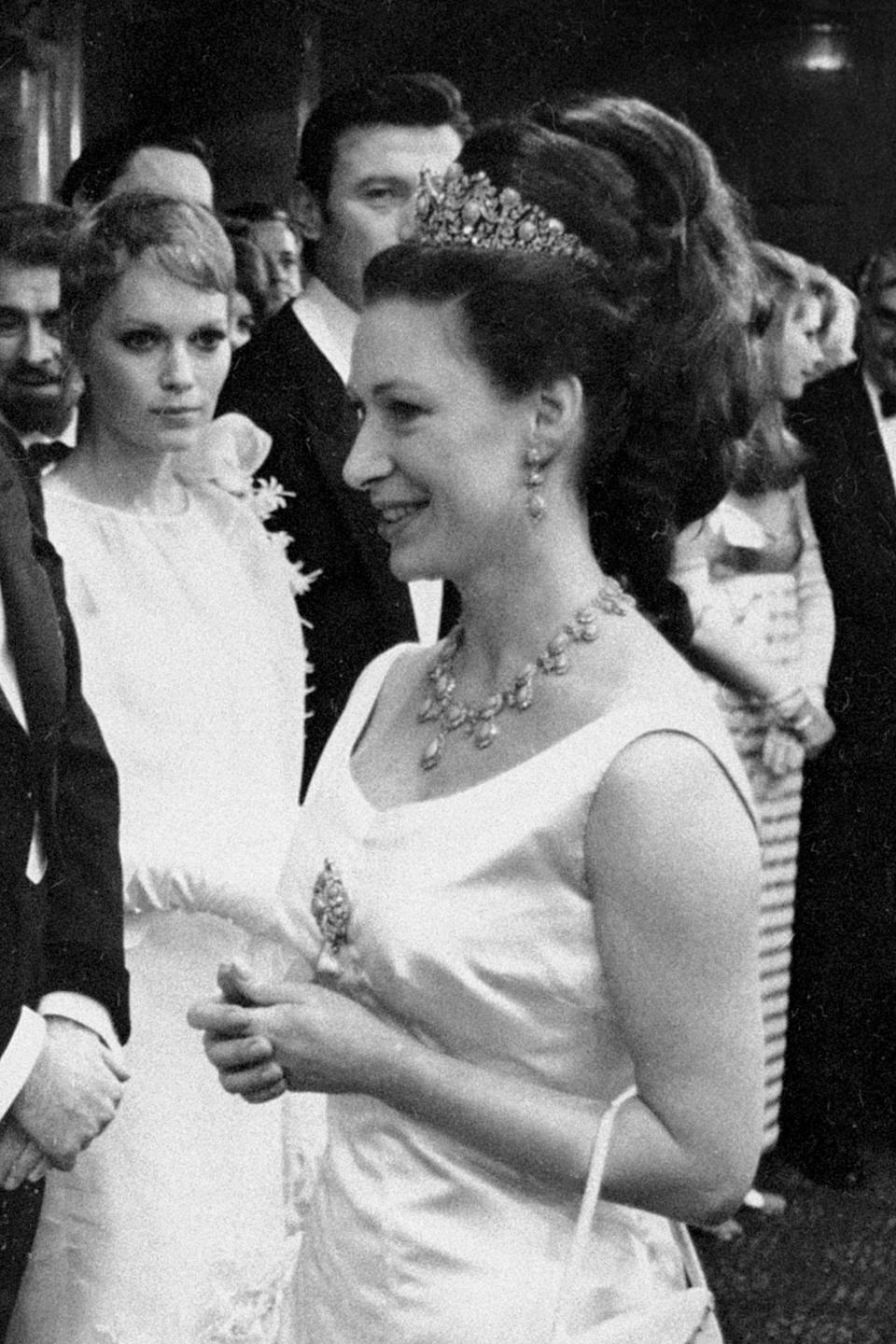 Margaret at the royal performance of "The Taming of the Shrew," the film starring Elizabeth Taylor and Richard Burton. Actors Mia Farrow and Lawrence Harvey are in the background.