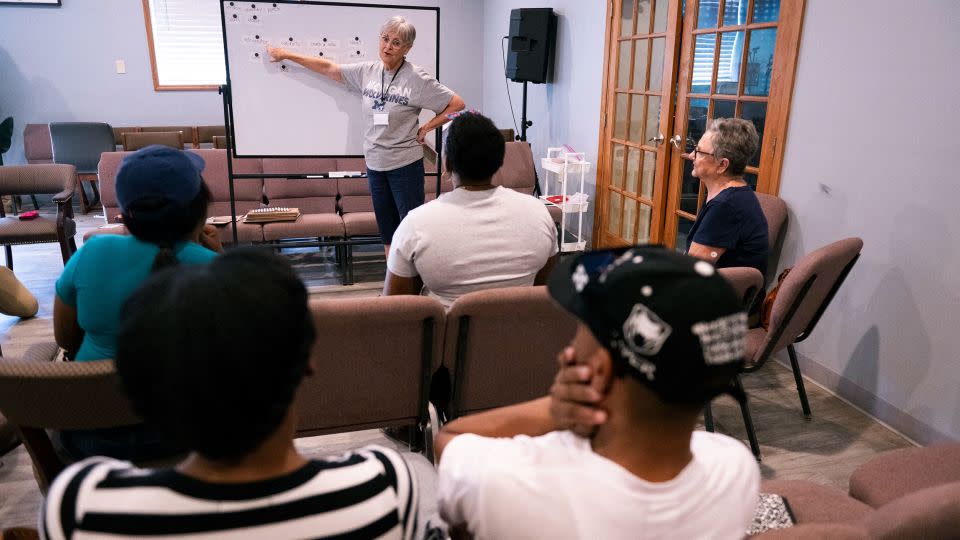 Volunteer teacher Hope Kaufman leads Haitian students during an English language class at the Haitian Community Help and Support Center in Springfield on September 13. - Roberto Schmidt/AFP/Getty Images