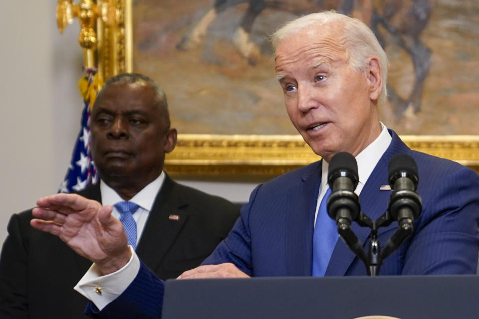 President Joe Biden delivers remarks on recovery efforts for the Maui wildfires and the response to Hurricane Idalia, in the Roosevelt Room of the White House, Wednesday, Aug. 30, 2023, in Washington. Secretary of Defense Lloyd Austin, left, stand sbehind Biden. (AP Photo/Evan Vucci)