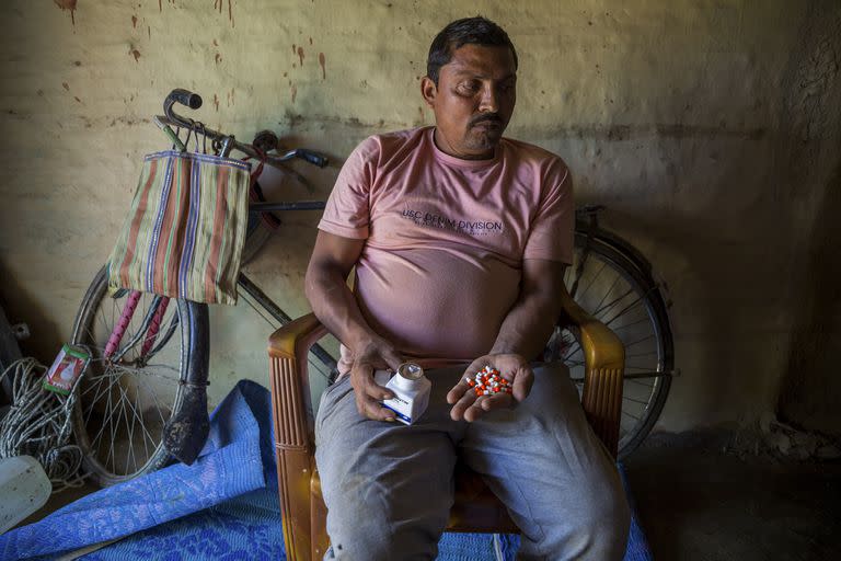 Shambhu Chaudhary sostiene las pastillas que toma para controlar el mareo, un efecto persistente de sus años de trabajo en el calor extremo de Qatar