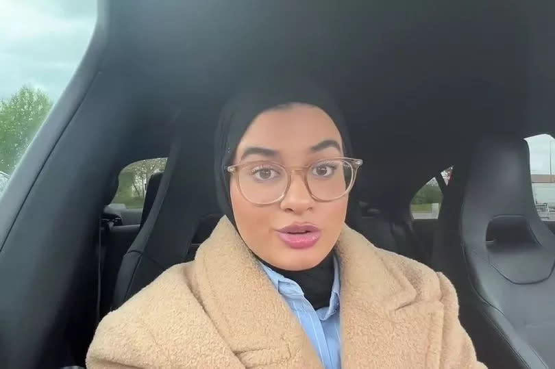 A woman talking to the camera in a car