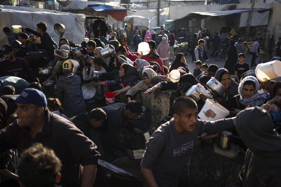 Palestinians line up for a free meal in Rafah, Gaza Strip, on Tuesday, March 12, 2024. (AP Photo/Fatima Shbair)