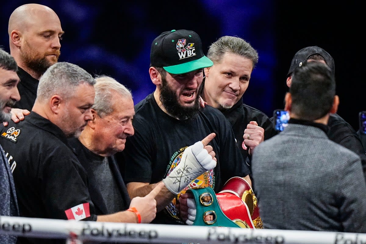 Beterbiev (centre) celebrates his stoppage win over Callum Smith (Getty Images)