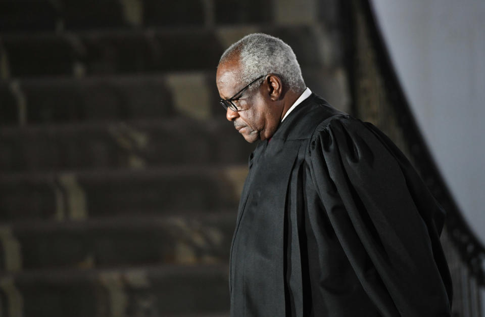 Justice Thomas is shown wearing a robe and looking off camera