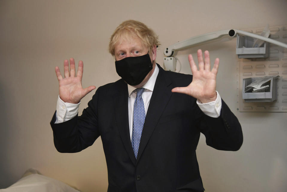 Britain's Prime Minister Boris Johnson gestures during a visit to Tollgate Medical Centre in Beckton, East London, Friday July 24, 2020. (Jeremy Selwyn/Pool Photo via AP)