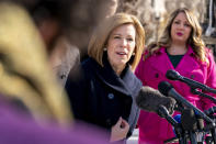 Lawyer Kristen Waggoner of the Alliance Defending Freedom, center, accompanied by by her client, Lorie Smith, a Christian graphic artist and website designer in Colorado, right in pink coat, speaks outside the Supreme Court in Washington, Monday, Dec. 5, 2022, after arguing before the Court. The Supreme Court is hearing the case of Smith who objects to designing wedding websites for gay couples, that's the latest clash of religion and gay rights to land at the highest court. (AP Photo/Andrew Harnik)