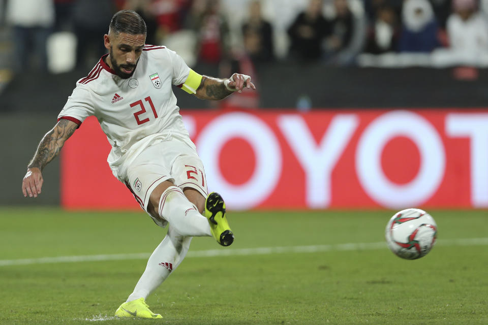 Iran's midfielder Ashkan Dejagah, right, scores his side's second goal from the penalty spot during the AFC Asian Cup round of 16 soccer match between Iran and Oman at Mohammed Bin Zayed Stadium in Abu Dhabi, United Arab Emirates, Sunday, Jan. 20, 2019. (AP Photo/Kamran Jebreili)