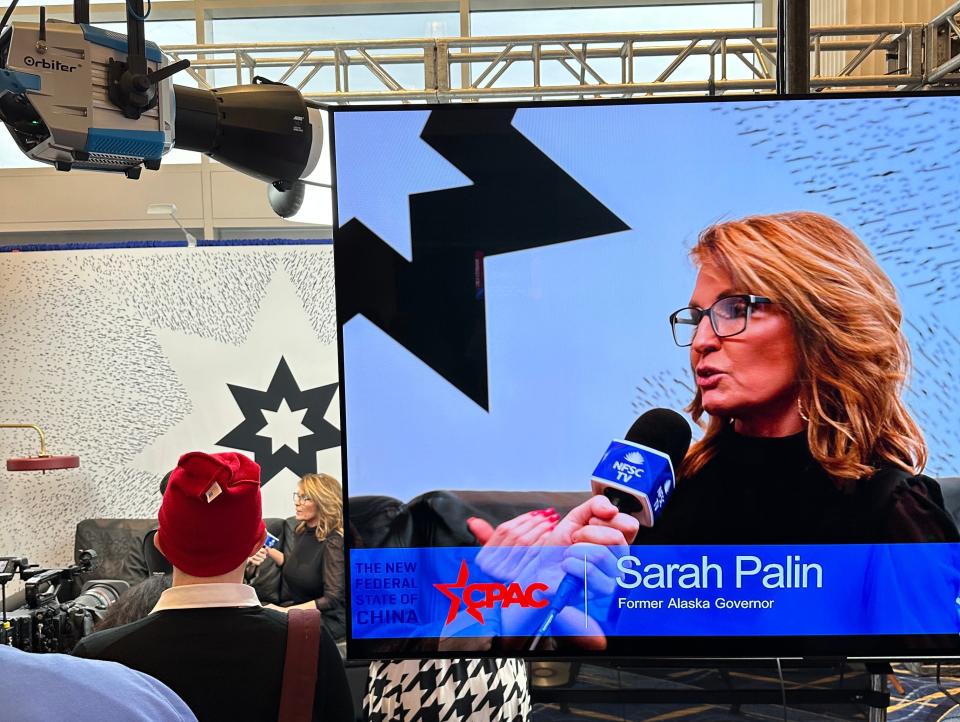 Palin speaks at a "New Federal State of China" media booth at CPAC on March 3, 2023.