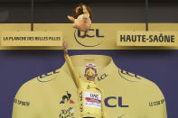 Stage winner and new overall leader, best young rider and best climber, Slovenia's Tadej Pogacar, wearing the yellow jersey, celebrates on the podium after stage 20 of the Tour de France cycling race, an individual time trial over 36.2 kilometers (22.5 miles), from Lure to La Planche des Belles Filles, France, Saturday, Sept. 19, 2020. (Marco Bertorello/Pool via AP)