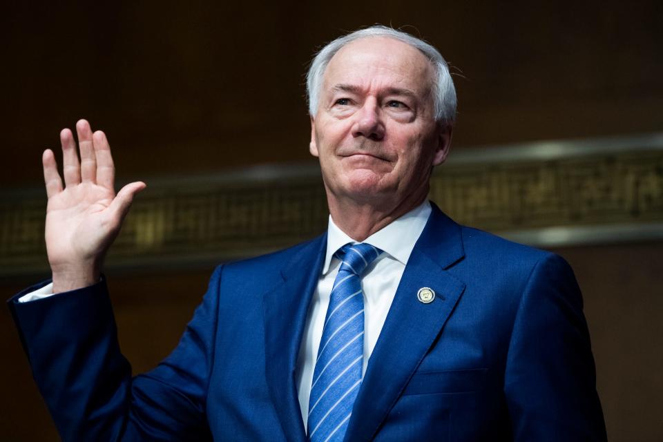 Arkansas governor Asa Hutchinson holds his hand up to be sworn into a Senate Judiciary Committee hearing on June 22, 2021.