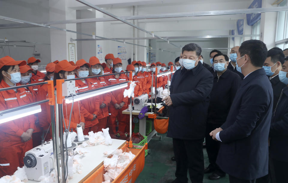 In this April 21, 2020 photo released by China's Xinhua News Agency, Chinese President Xi Jinping wears a face mask as he inspects a factory production line in Laoxian township in Ankang city in northwestern China's Shaanxi Province. (Ju Peng/Xinhua via AP)