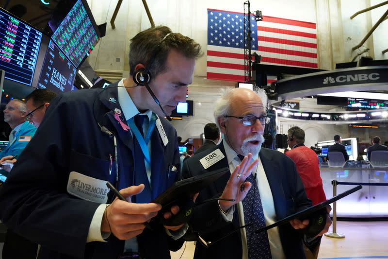 Traders work at the New York Stock Exchange