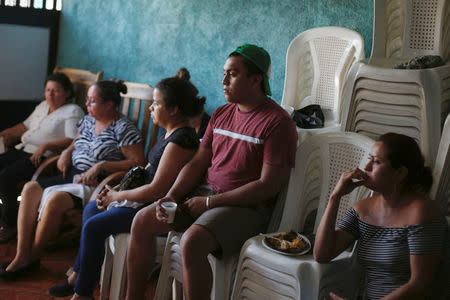 Relatives and friends sit next to the coffin of Darwin Manuel Urbina, 29, who according to nation's Red Cross was shot dead during a protest over a controversial reform to the pension plans of the Nicaraguan Social Security Institute (INSS) in Managua, Nicaragua April 21, 2018. REUTERS/Jorge Cabrera