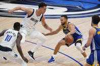 Golden State Warriors guard Stephen Curry controls the ball next to Dallas Mavericks center Dwight Powell (7) during the second half of Game 4 of the NBA basketball playoffs Western Conference finals, Tuesday, May 24, 2022, in Dallas. (AP Photo/Tony Gutierrez)