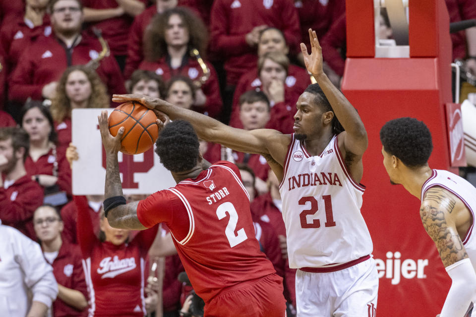 Indiana forward Mackenzie Mgbako (21) blocks a shot attempt by Wisconsin guard AJ Storr (2) during the second half of an NCAA college basketball game, Tuesday, Feb. 27, 2024, in Bloomington, Ind. (AP Photo/Doug McSchooler)