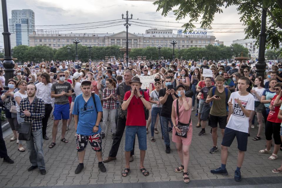 People holding posters reading "freedom for Sergei Furgal" gather to attend an unsanctioned protest in support of Sergei Furgal, the governor of the Khabarovsk region, who was interrogated ordered held in jail for two months, in Khabarovsk, 6100 kilometers (3800 miles) east of Moscow, in Russia, Monday, July 13, 2020. Thousands of protesters gathered Monday for a third straight day of massive protests in Russia's far east against the jailing of a provincial governor accused of involvement in multiple murders. Demonstrators in Khabarovsk on the border with China have rejected the charges against Gov. (AP Photo/Igor Volkov)