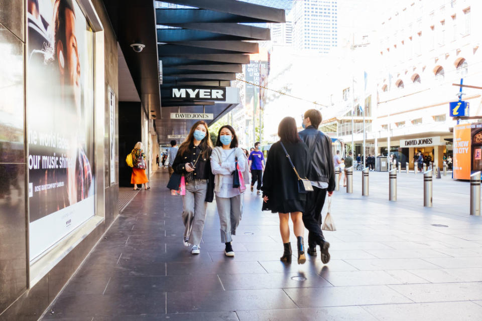 People walk through Bourke Street Mall in Melbourne. 