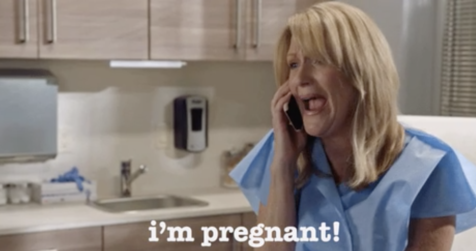 A woman saying, "I'm pregnant!" on the phone