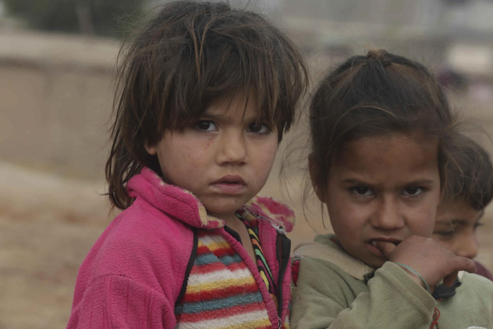 In this Thursday, Feb. 13, 2020 photo, Afghan refugee children who fled their country, walk in the Kabobayan refugee camp, Peshawar, Pakistan. After 40 years, more than 1. 5 million Afghans still live as refugees in Pakistan, feeling abandoned by their own government, increasingly unwelcome by their reluctant host country and ignored by the United Nations. (AP Photo/Muhammad Sajjad)