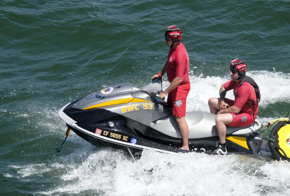 Members of the Ventura County Sheriff's Office search for former "Glee" actress Naya Rivera, Thursday, July 9, 2020, at Lake Piru in Los Padres National Forest, northwest of Los Angeles. Rivera rented a boat Wednesday and her 4-year-old son was found alone on the boat. (AP Photo/Ringo H.W. Chiu)