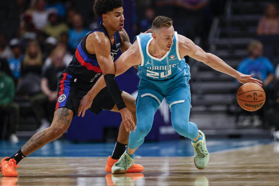 Charlotte Hornets forward Gordon Hayward, right, tries to control the ball against Detroit Pistons guard Killian Hayes, left, during the first quarter of an NBA basketball game in Charlotte, N.C., Friday, Oct. 27, 2023. (AP Photo/Nell Redmond)