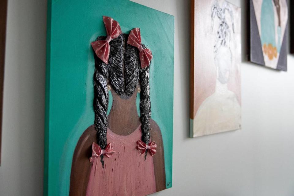 One of KC Artist, Christa Rice’s, favorite paintings with three dimensional features. Rice has made Black hair her muse and features it in much of her work.